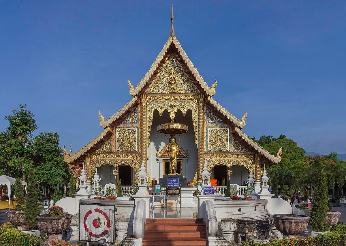 The gilded front of the main hall at Wat Phra Singh temple in Chiang Mai under a clear blue sky